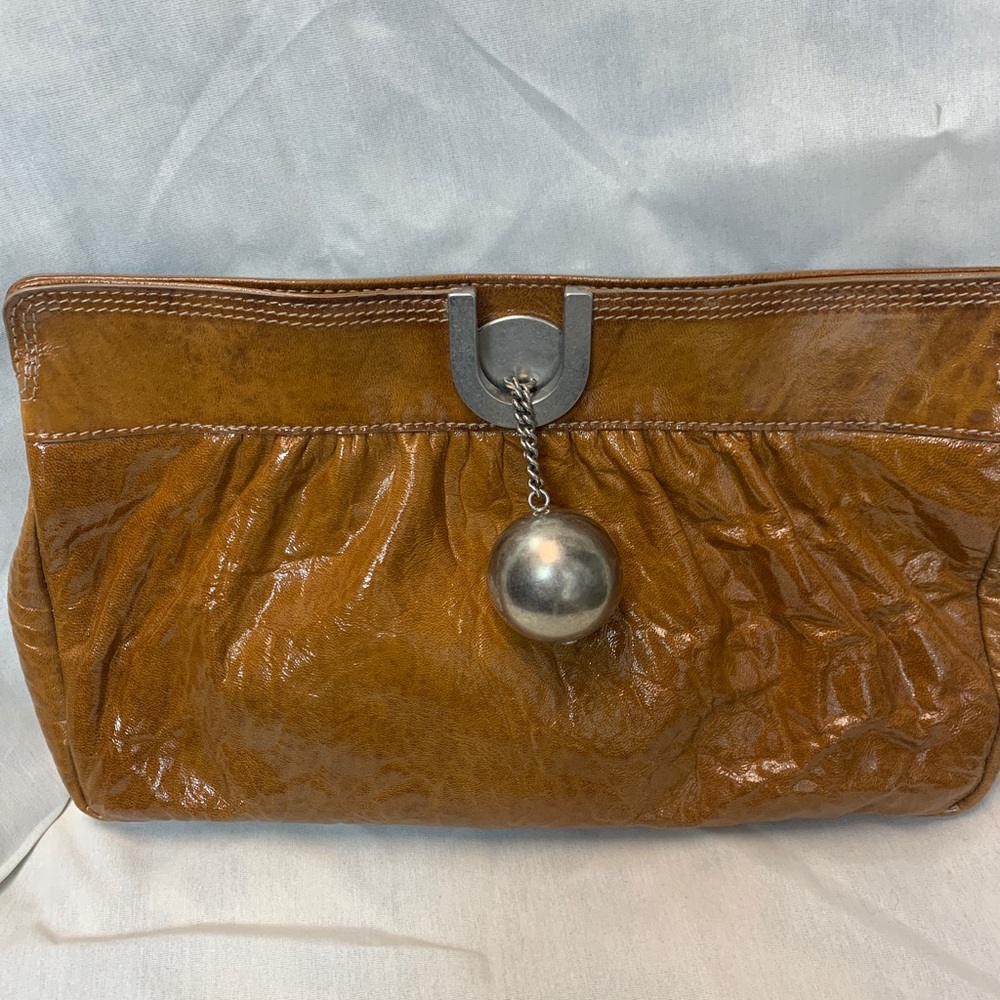 Chloe brown patent leather clutch with silver ball and chain.